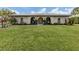 Inviting home exterior with a lush lawn, arched entryway, and cheerful yellow door at 641 Verrocchio Dr, Nokomis, FL 34275