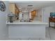 Bright kitchen featuring tile floors, light wood cabinets, and an eat-in bar at 641 Verrocchio Dr, Nokomis, FL 34275