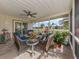 Screened-in lanai with wicker furniture, ceiling fan, and view of the backyard at 641 Verrocchio Dr, Nokomis, FL 34275