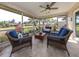 Screened-in lanai with wicker furniture and views of the backyard at 641 Verrocchio Dr, Nokomis, FL 34275