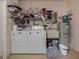 Laundry room with washer, dryer, shelving, and storage space at 641 Verrocchio Dr, Nokomis, FL 34275