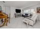 Bright living room with tile flooring, neutral walls, and comfortable furnishings at 641 Verrocchio Dr, Nokomis, FL 34275