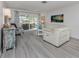 Comfortable living room with white sofa, sliding doors, and stylish decor at 641 Verrocchio Dr, Nokomis, FL 34275