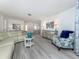 Open-concept living space with wood flooring, leading into dining area at 641 Verrocchio Dr, Nokomis, FL 34275