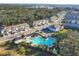 An aerial view of the community pool nestled among townhome-style residences and lush green trees at 6634 Calypso Coral Ln, Sarasota, FL 34240