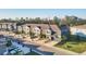 Aerial view of townhomes with palm trees, green spaces, and a community park at 6634 Calypso Coral Ln, Sarasota, FL 34240