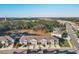 Aerial view of a residential community with a pool, pond, playground, and surrounding green spaces at 6634 Calypso Coral Ln, Sarasota, FL 34240