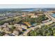Aerial view of a residential community with a pool, pond, and surrounding green spaces at 6634 Calypso Coral Ln, Sarasota, FL 34240