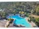 Aerial view of the community pool, featuring palm trees, lounge chairs, and a covered seating area at 6634 Calypso Coral Ln, Sarasota, FL 34240