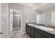 Bathroom featuring double sinks with granite countertop and a tiled shower at 6634 Calypso Coral Ln, Sarasota, FL 34240