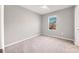 Bedroom with neutral carpet, paint, and a view of neighborhood homes at 6634 Calypso Coral Ln, Sarasota, FL 34240