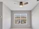 Bright bedroom with a ceiling fan and large window showcasing the outside at 6634 Calypso Coral Ln, Sarasota, FL 34240