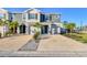 Modern townhome with stone accents, a two-car garage, and tropical landscaping at 6634 Calypso Coral Ln, Sarasota, FL 34240