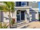 Inviting front porch with stone pillars, dark wood front door, and a two-car garage at 6634 Calypso Coral Ln, Sarasota, FL 34240