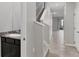 Open hallway and staircase with a bathroom featuring a marble countertop sink at 6634 Calypso Coral Ln, Sarasota, FL 34240