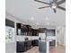 Modern kitchen featuring dark cabinets, a kitchen island, stainless steel appliances, and natural light at 6634 Calypso Coral Ln, Sarasota, FL 34240