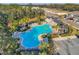 Community pool featuring lounge chairs and lush landscaping near residences, adding an oasis feel at 6634 Calypso Coral Ln, Sarasota, FL 34240