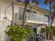 Outdoor balcony featuring an outdoor dining set, railing, and an entry to the condo at 6701 Gulf Of Mexico Dr # 311, Longboat Key, FL 34228