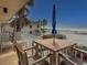 Relax on this cozy balcony offering great views, a dining table and seating area at 6701 Gulf Of Mexico Dr # 311, Longboat Key, FL 34228