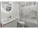 Modern bathroom featuring marble-like tile in shower/tub, sleek vanity and updated fixtures at 6701 Gulf Of Mexico Dr # 311, Longboat Key, FL 34228