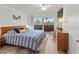 Cozy bedroom with a striped bedspread, wooden furniture, and natural light streaming in at 6701 Gulf Of Mexico Dr # 311, Longboat Key, FL 34228