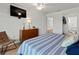 Comfortable bedroom with wooden dresser, and a view to the ensuite bathroom at 6701 Gulf Of Mexico Dr # 311, Longboat Key, FL 34228