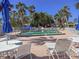 Another view of the community pool with poolside seating and umbrellas at 6701 Gulf Of Mexico Dr # 311, Longboat Key, FL 34228