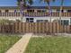 View of condo building with private fenced patios and balconies at 6701 Gulf Of Mexico Dr # 311, Longboat Key, FL 34228