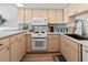 Modern kitchen features updated appliances and a stylish backsplash for easy cooking at 6701 Gulf Of Mexico Dr # 311, Longboat Key, FL 34228