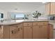 Kitchen offers ample counter space and a view of the ocean and living area at 6701 Gulf Of Mexico Dr # 311, Longboat Key, FL 34228