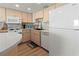Well-lit kitchen featuring modern appliances and cabinetry, perfect for cooking at 6701 Gulf Of Mexico Dr # 311, Longboat Key, FL 34228