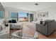 Inviting living room featuring ocean views from a large sliding glass door and cozy furniture at 6701 Gulf Of Mexico Dr # 311, Longboat Key, FL 34228