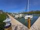Dock in the marina with sail boats and a glimpse of a boat house at 6701 Gulf Of Mexico Dr # 311, Longboat Key, FL 34228