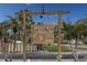 Whitney Beach condo complex sign surrounded by mature palm trees in a beautiful beach community at 6701 Gulf Of Mexico Dr # 311, Longboat Key, FL 34228