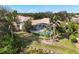 Aerial view of a home with a screened pool surrounded by palm trees at 6922 Stanhope Pl, University Park, FL 34201