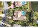 Aerial view of home showing screened pool, tile roof and mature landscaping at 6922 Stanhope Pl, University Park, FL 34201