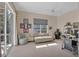 Bright bedroom with a ceiling fan, sitting area, and sliding glass doors to a balcony at 6922 Stanhope Pl, University Park, FL 34201