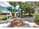 The club entrance with covered awning, brick walkway, and manicured landscaping at 6922 Stanhope Pl, University Park, FL 34201