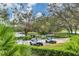 Community featuring multiple golf carts parked near a serene lake and lush greenery at 6922 Stanhope Pl, University Park, FL 34201