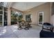 Covered patio with an outdoor dining table and grill, perfect for entertaining at 6922 Stanhope Pl, University Park, FL 34201