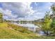 Scenic view of the pond, reflecting clouds and palm trees at 6922 Stanhope Pl, University Park, FL 34201