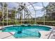 Screened pool and spa with lush landscaping creating a private backyard retreat at 6922 Stanhope Pl, University Park, FL 34201