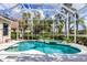 Backyard pool and spa are surrounded by a screened enclosure and lush landscaping at 6922 Stanhope Pl, University Park, FL 34201