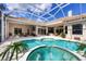 Large screened lanai with pool, spa and plenty of room for outdoor dining and relaxing at 6922 Stanhope Pl, University Park, FL 34201