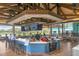 Outdoor restaurant bar area with TVs, wood floors, and seating for patrons at 6922 Stanhope Pl, University Park, FL 34201
