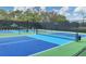 Active community with well-maintained blue and green tennis courts and lush landscaping at University Park at 6922 Stanhope Pl, University Park, FL 34201