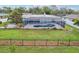 A large screened lanai houses a pool and pool deck, with a manicured lawn surrounding it at 730 Magellan Dr, Sarasota, FL 34243