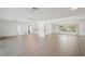 Spacious living room with tile floors and abundant natural light from large windows at 730 Magellan Dr, Sarasota, FL 34243