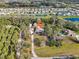 Aerial view of a home nestled among trees and surrounded by ponds in a residential neighborhood at 7415 36Th E Ave, Palmetto, FL 34221