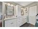 Bathroom featuring double sinks, white cabinets, and a mosaic-framed mirror at 7415 36Th E Ave, Palmetto, FL 34221